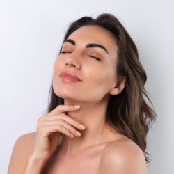 Close-up beauty portrait of a topless woman with perfect skin and natural make-up