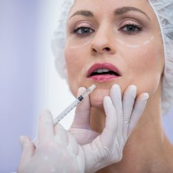 Portrait of woman receiving botox injection at clinic